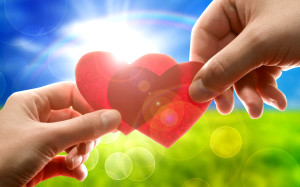 Female and man's hands with red hearts
